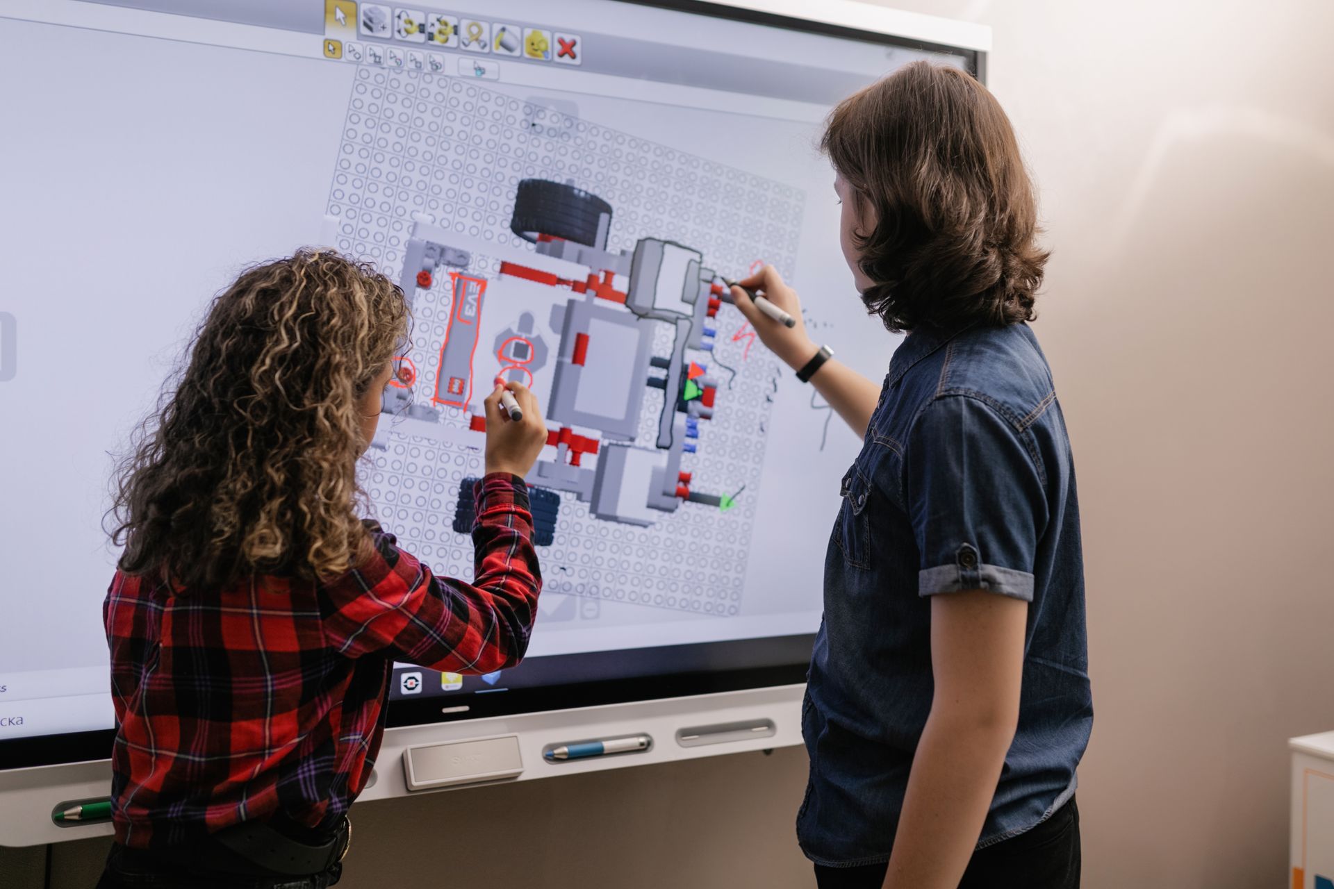 Two students working together at an interactive board